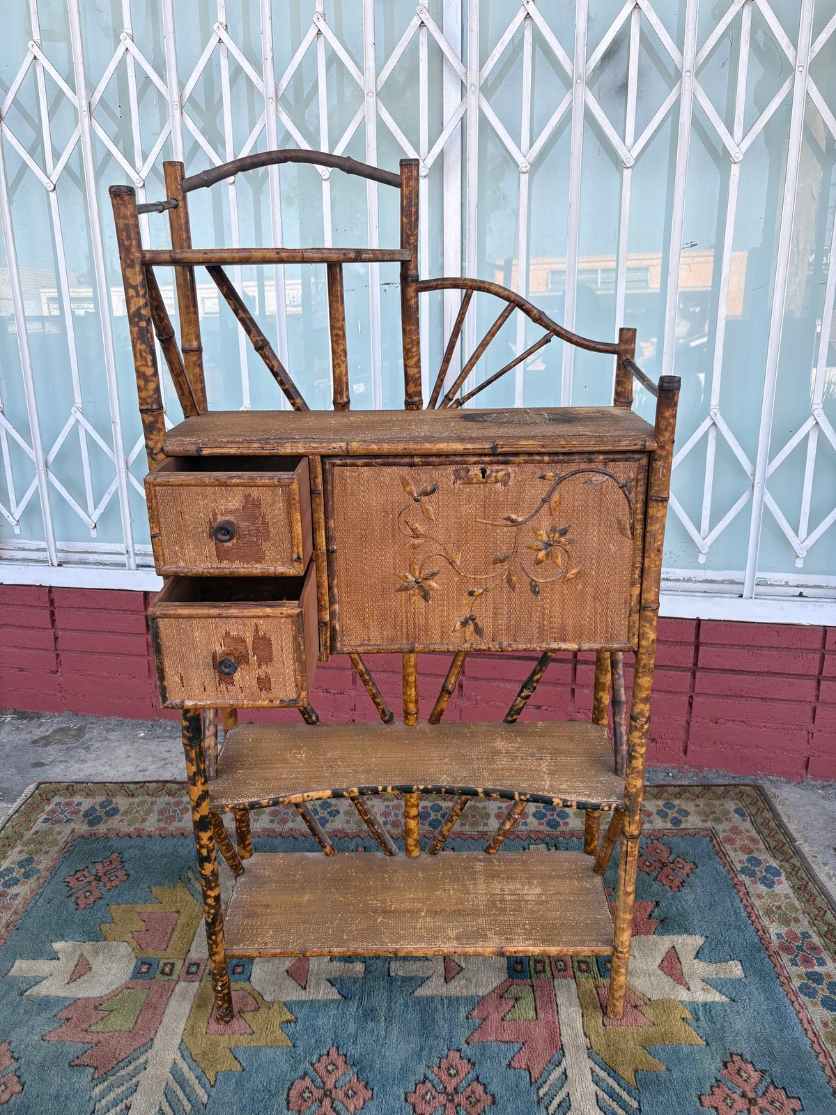 Vintage wooden secretary desk with shelves and drawers featuring decorative spindle back design