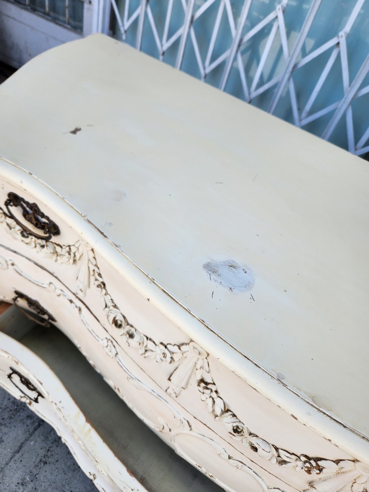 Close-up of white boat hull and deck with peeling paint and weathering damage