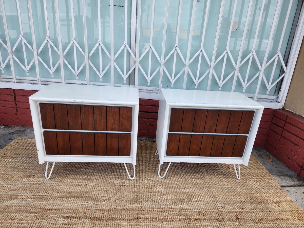 Two mid-century modern credenzas with white frames and dark wood fronts, displayed outdoors on a brick patio.