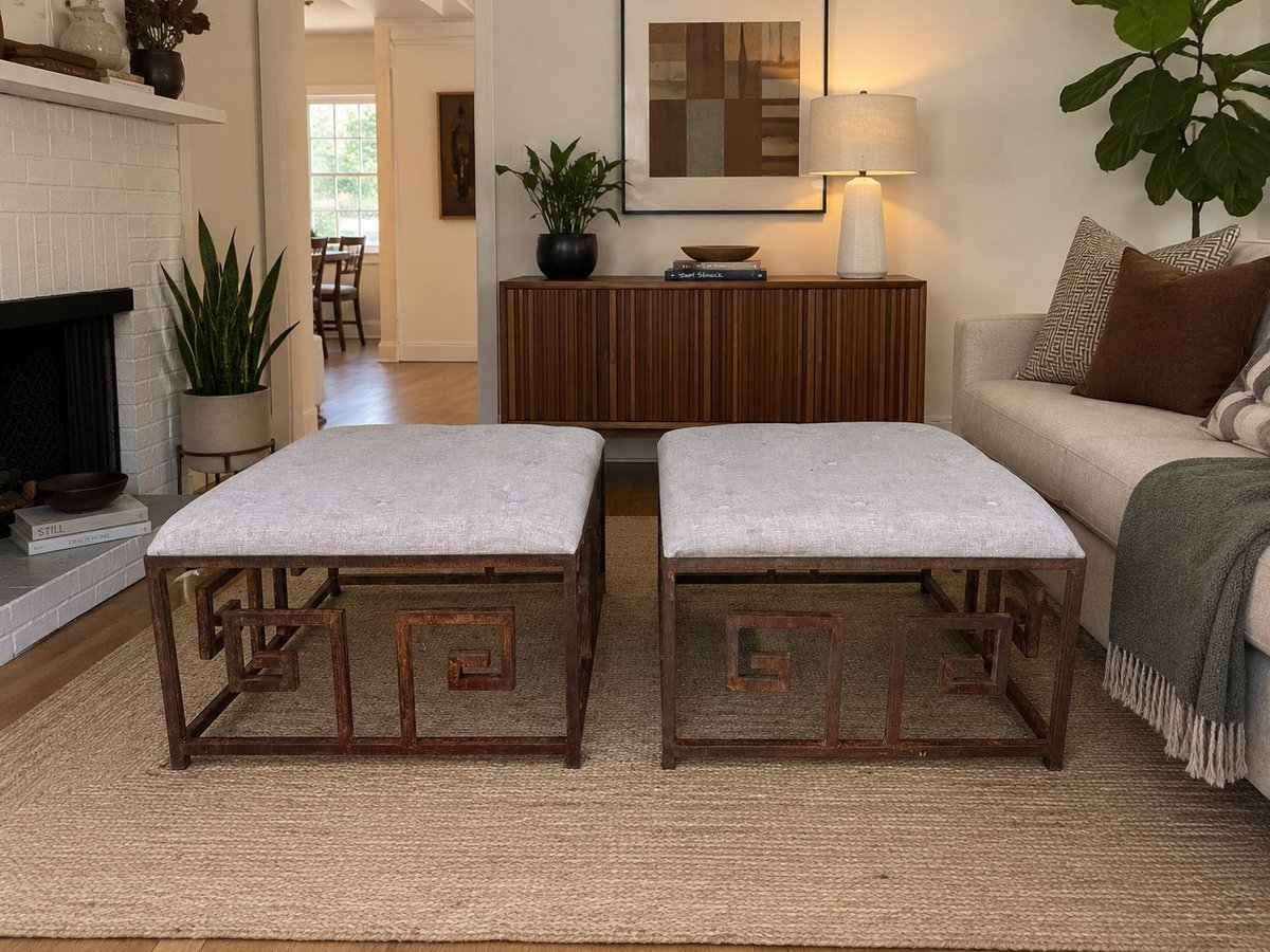 Two wooden ottomans with light gray cushions in a bright living room with fireplace, sofa, and decorative elements.