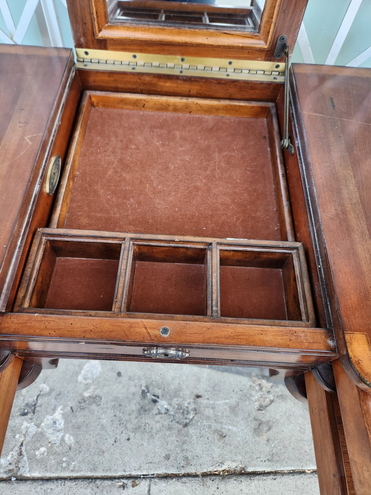 Open wooden jewelry box with burgundy velvet-lined tray and three compartments below, showing mirror and metal ruler on lid