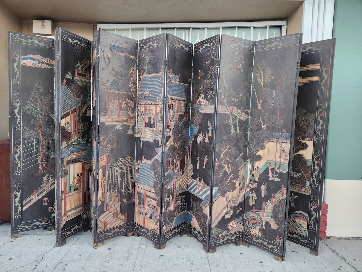 Antique black lacquer folding room divider screen with intricate gold painted Asian landscape and architectural scenes
