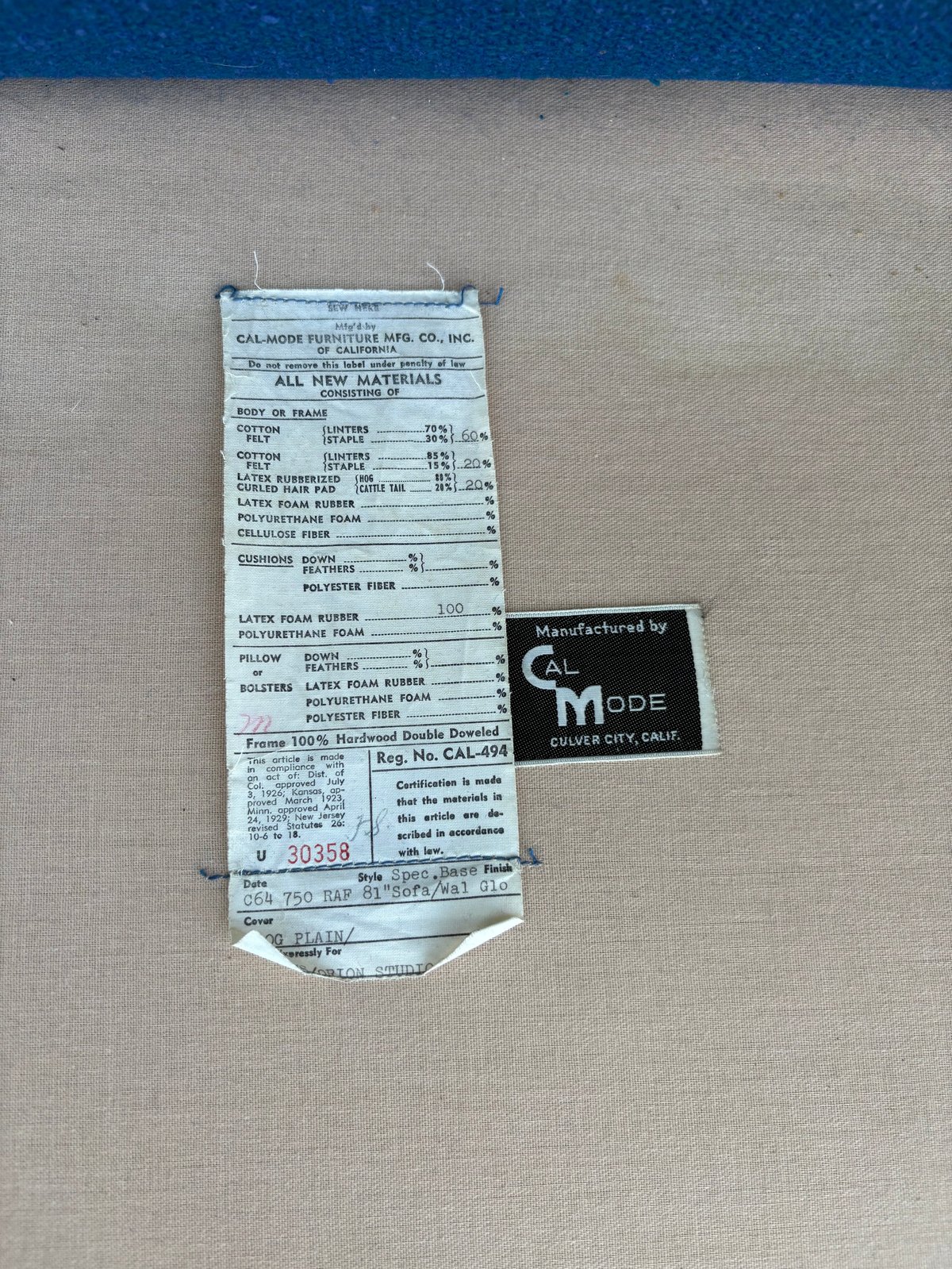 Vintage furniture tag from Calmode showing materials list and Calmode manufacturer label from Culver City, California on cream fabric