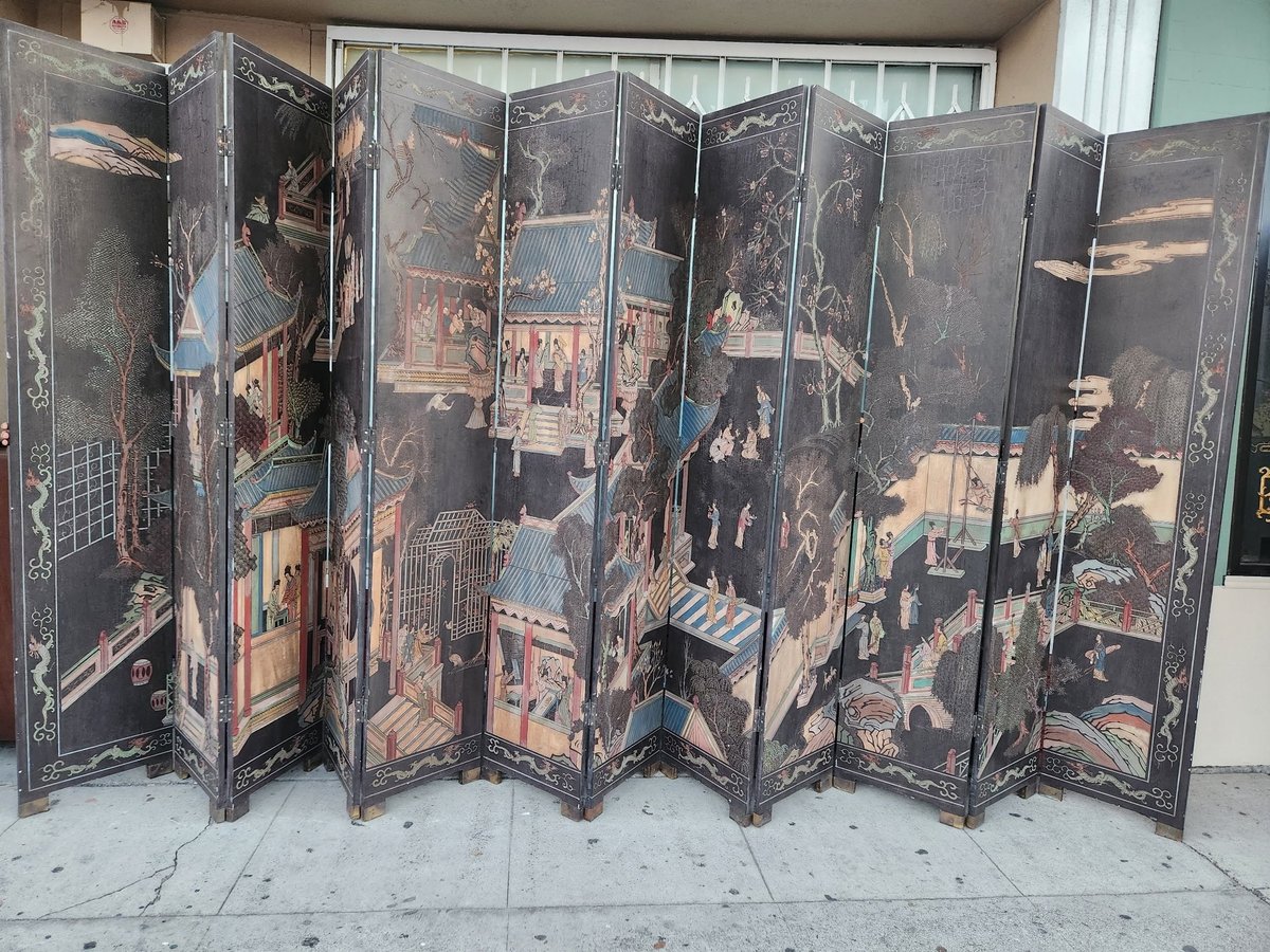 Antique black lacquer folding room divider with gold-leaf painted scenes of figures and landscapes